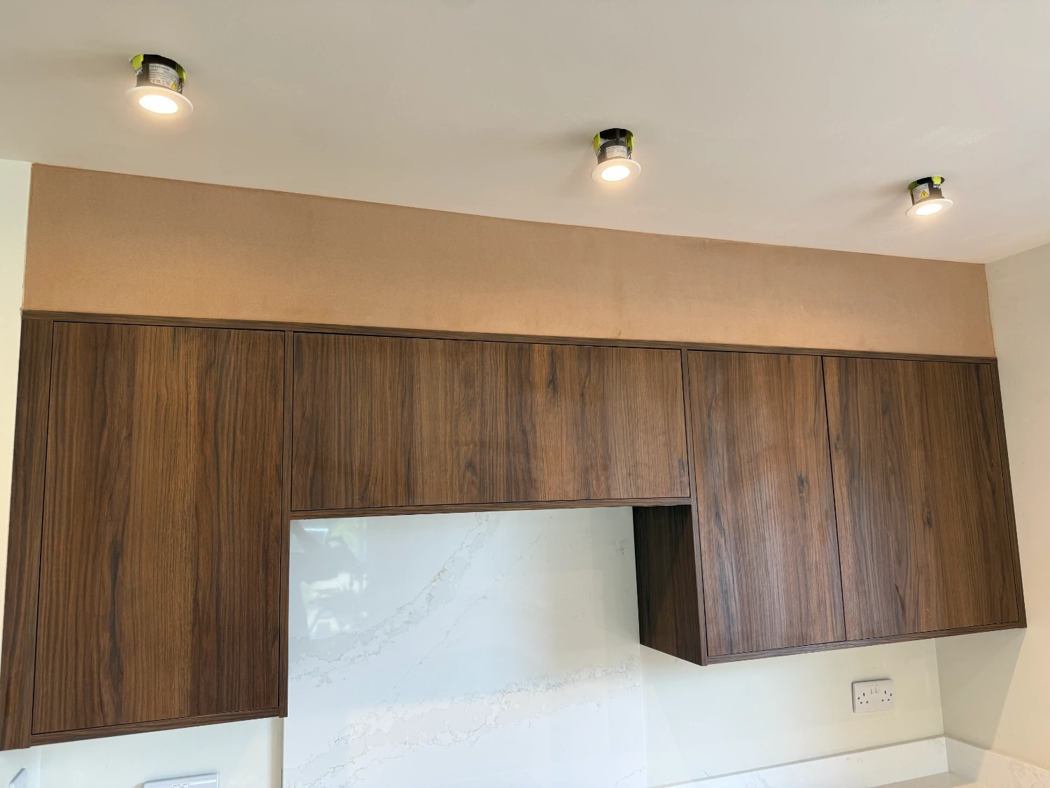 The same kitchen bulkhead skimmed, running straight above the units