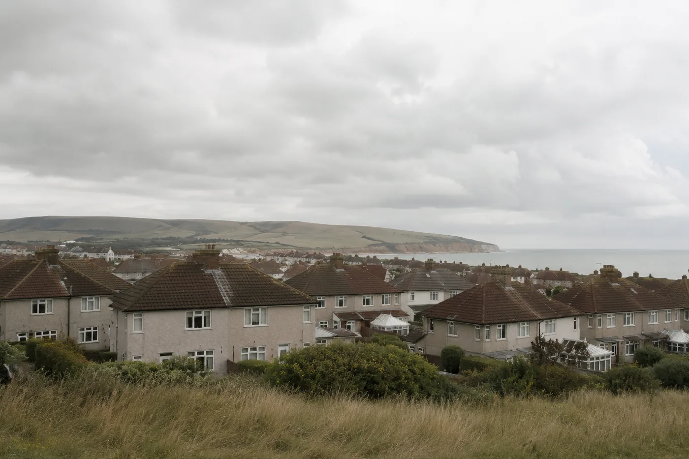 Rooftops of the coastal strip with the downs and the sea behind them