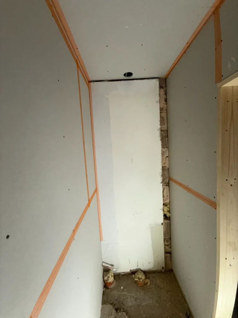 A small room boarded out and taped at every joint, ready for skimming