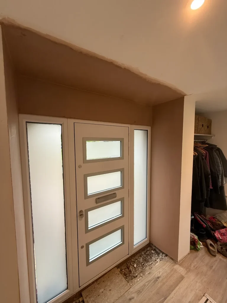 The finished plaster around a front door, with nothing left to show where the wall was made good