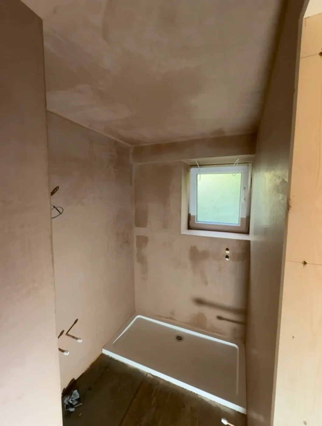 The same bathroom skimmed, with the shower tray in place